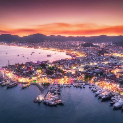 Aerial view of boats and beautiful city at night in Marmaris