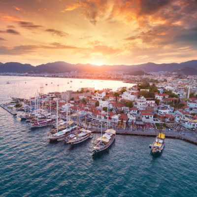 Aerial view of boats and yahts and beautiful city at sunset